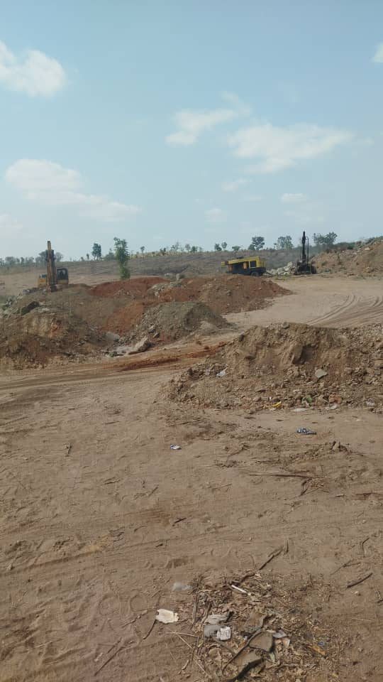 Excavator and drill rig at our mining site